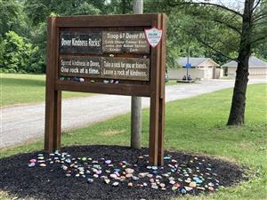Kindness Rocks Garden sign with painted rocks in the mulch below