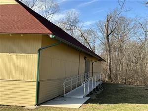 ADA ramp to Dance Hall - rectangular building with metal ramp leading to green door.