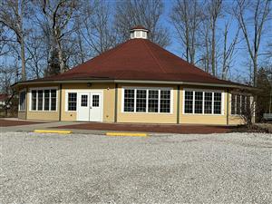 Carousel - round building with peaked roof and windows all around.