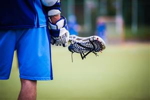 A boy holding a lacrosse stick