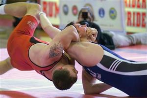 Men grappling on wrestling mat