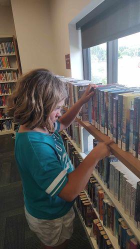 girl checking books library